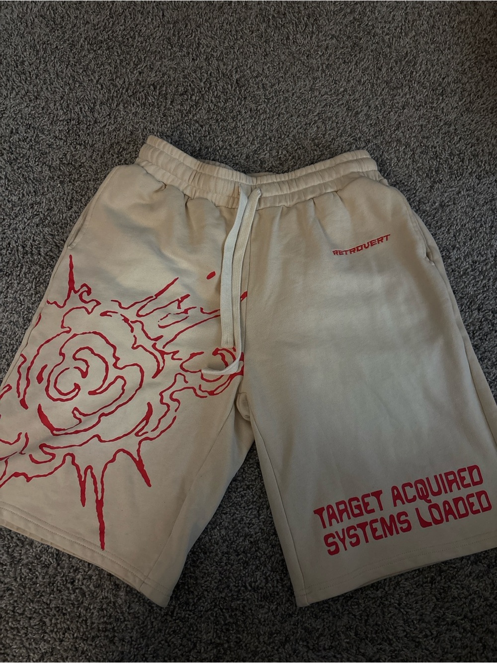 Beige Athletic Shorts with Red Graphic Print